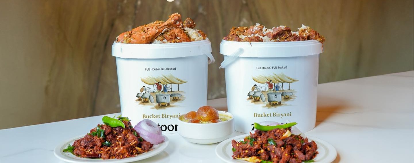 Bucket Malabar biryani with eri pori sides and saffron rabadi